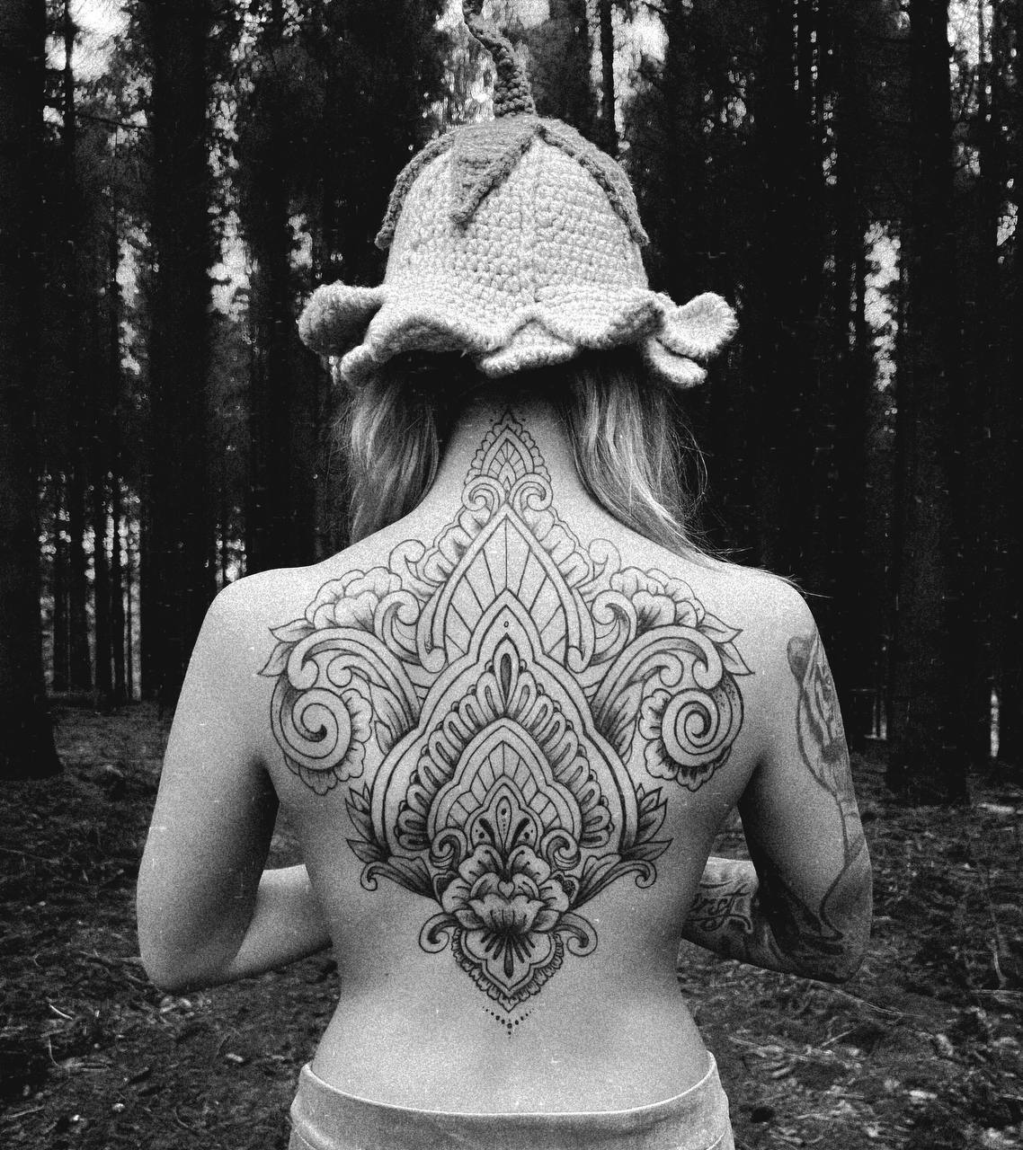 Large symmetrical ornamental back tattoo