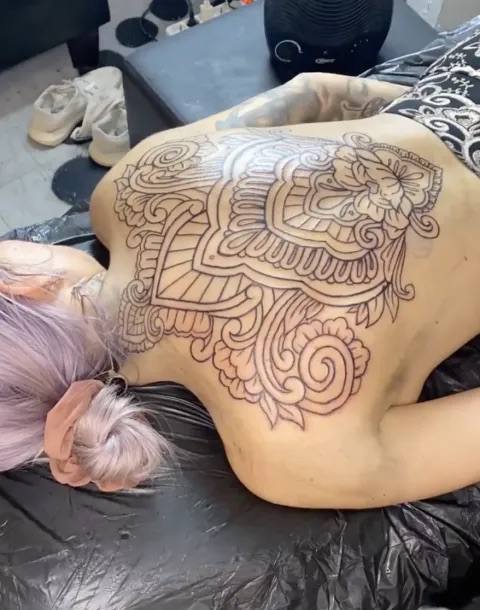 Ornamental back tattoo in progress