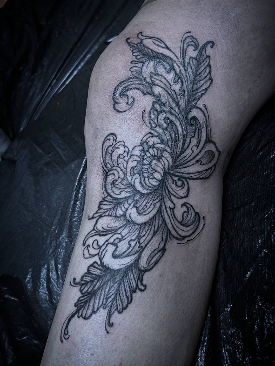 Floral bird tattoo on arm